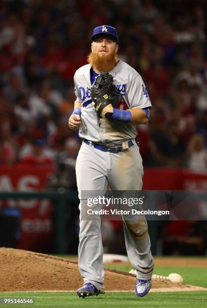 Justin Turner of the Los Angeles Dodgers jogs back to the dugout after the eighth inning during the MLB game against the Los Angeles Angels of...