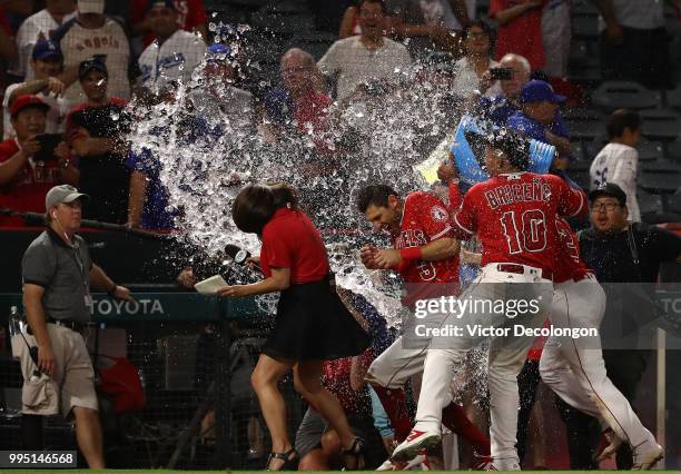 Ian Kinsler of the Los Angeles Angels of Anaheim is doused with a sports drink by teammates Jose Briceno and Andrelton Simmons after their MLB game...