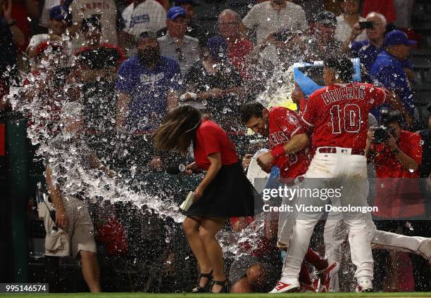 Ian Kinsler of the Los Angeles Angels of Anaheim is doused with a sports drink by teammates Jose Briceno and Andrelton Simmons after their MLB game...