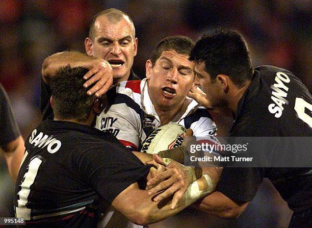 Bryan Fletcher of the Roosters gets tackled by Jody Gall, Ned Catic and Craig Gower of the Panthers during the NRL round 20 match betwen the Penrith...