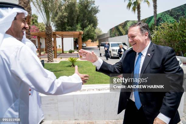 Secretary of State Mike Pompeo and Abu Dhabi's Crown Prince Sheikh Mohammed bin Zayed Al Nahyan prepare to shake hands as they meet at Al-Shati...