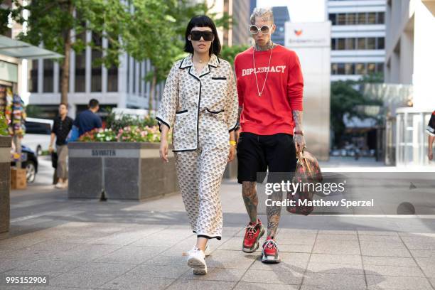 Michelle Song and Chris Lavish are seen on the street attending Men's New York Fashion Week on July 9, 2018 in New York City.