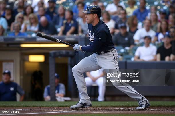Freddie Freeman of the Atlanta Braves hits a single in the first inning against the Milwaukee Brewers at Miller Park on July 7, 2018 in Milwaukee,...