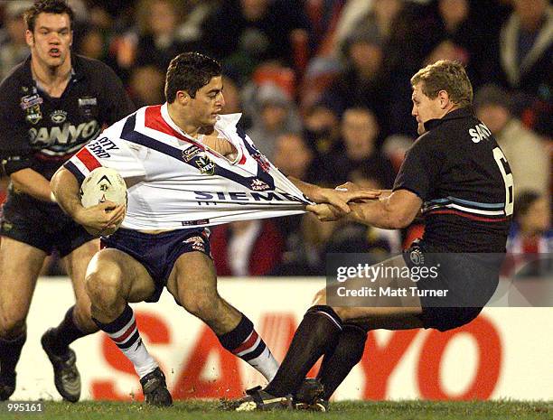 Anthony Minichiello of the Roosters gets tackled by Steve Carter of the Panthers during the NRL round 20 match betwen the Penrith Panthers and the...