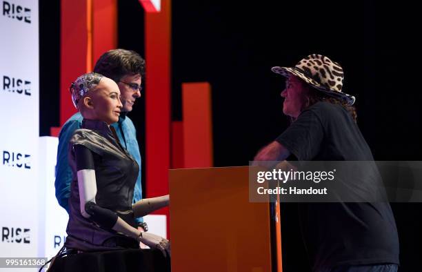 In this handout image provided by RISE, Hanson Robotics' Sophia The Robot, David Hanson, founder of Hanson Robotics and Ben Goertzel, chief scientist...