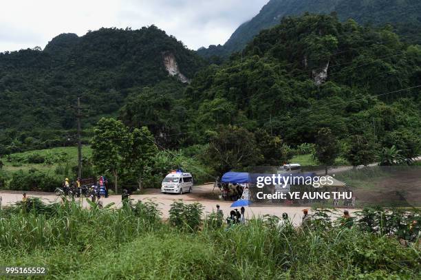 Ambulances leave the Tham Luang cave area as operations continue for those still trapped inside the cave in Khun Nam Nang Non Forest Park in the Mae...
