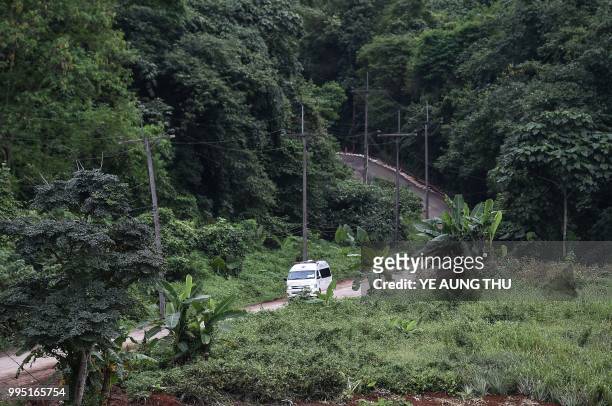 An ambulance leaves the Tham Luang cave area as operations continue for those still trapped inside the cave in Khun Nam Nang Non Forest Park in the...