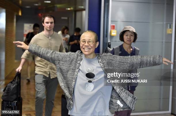 Liu Xia, the widow of Chinese Nobel dissident Liu Xiaobo, smiles as she arrives at the Helsinki International Airport in Vantaa, Finland, on July 10,...