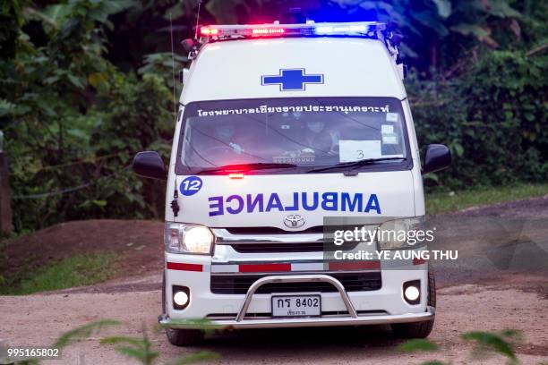 An ambulance leaves the Tham Luang cave area as operations continue for those still trapped inside the cave in Khun Nam Nang Non Forest Park in the...