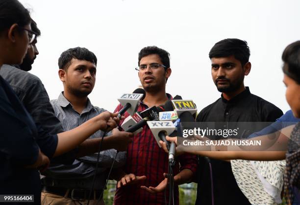 Indian petitioners Romel Barel, Krishna Reddy, and Anwesh Pokkuluri speak with the media near the Indian Supreme Court in New Delhi on July 10, 2018....