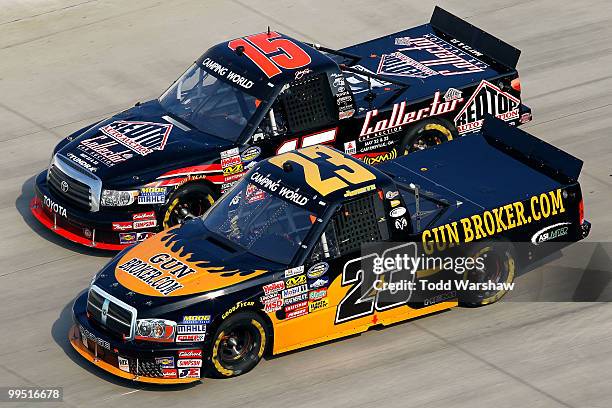 Johnny Benson drives the Red Top Auto Collector Toyota ahead of Jason White, driver of the GunBroker.com Dodge, during the NASCAR Camping World Truck...