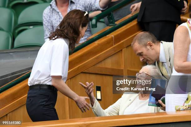Michelle Dockery greets Vanessa Redgrave as they attend day eight of the Wimbledon Tennis Championships at the All England Lawn Tennis and Croquet...