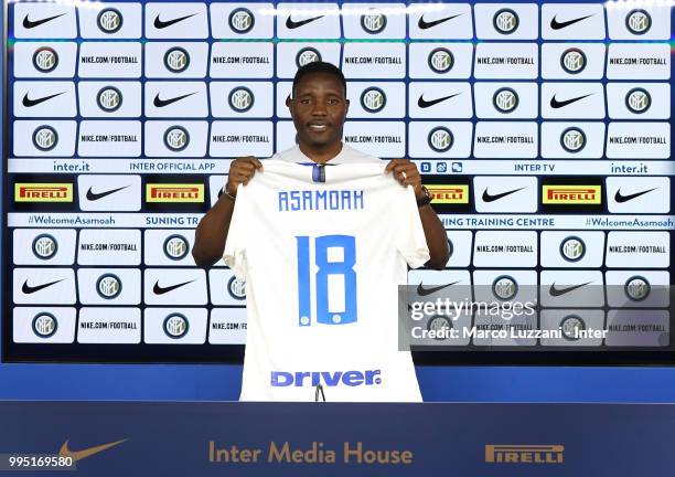 Internazionale new signing Kwadwo Asamoah poses with the club's jersey during a press conference at Appiano Gentile on July 10, 2018 in Como, Italy.