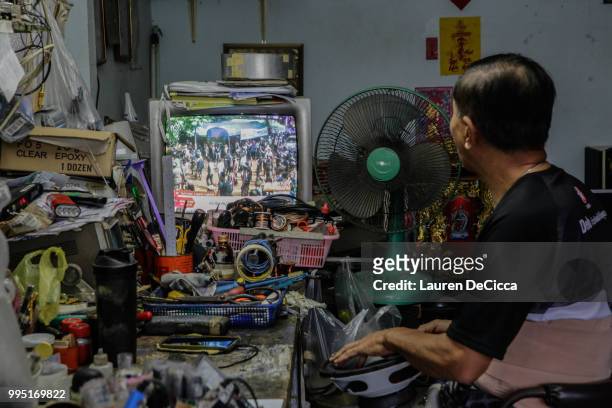 Television set broadcasting rescue efforts at a local shop near hospital Chiangrai Prachanukroh Hospital on July 10, 2018 in Chiang Rai, Thailand....