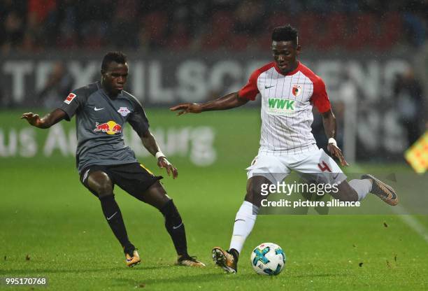 Bruma of Leipzig and Augsburg's Daniel Opare vie for the ball during the Bundesliga match between FC Augsburg and RB Leipzig at the WWK Arena in...