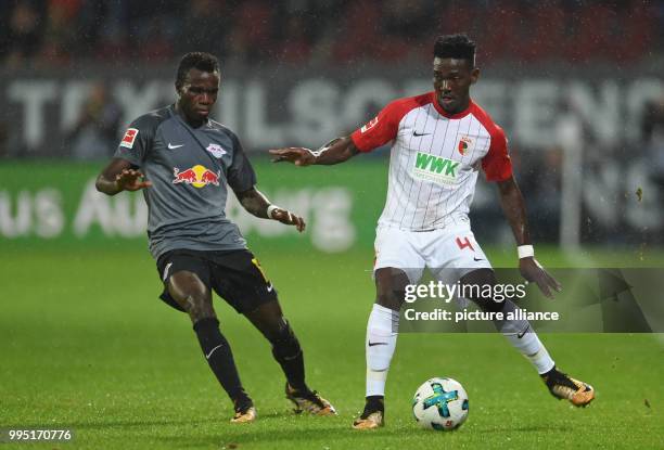 Bruma of Leipzig and Augsburg's Daniel Opare vie for the ball during the Bundesliga match between FC Augsburg and RB Leipzig at the WWK Arena in...