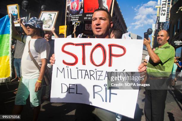 Protester seen holding a sign that says, Stop, militarization in the rif. Members of the Hirak movement in Madrid protest demanding the release of...
