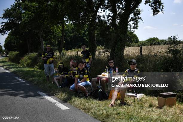 Fans of France's Direct Energie cycling team wait on the side of the road during the fourth stage of the 105th edition of the Tour de France cycling...