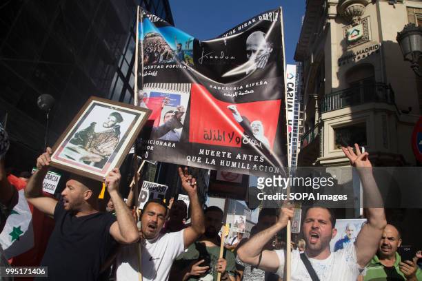 Protesters seen shouting while holding posters during the protest. Members of the Hirak movement in Madrid protest demanding the release of the...
