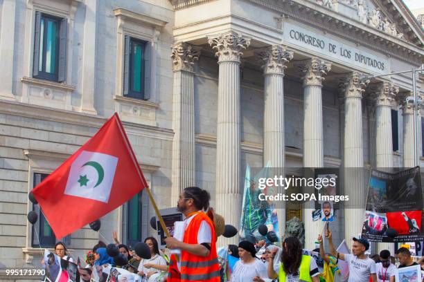 Man seen holding a flag during the protest. Members of the Hirak movement in Madrid protest demanding the release of the political prisoners of the...