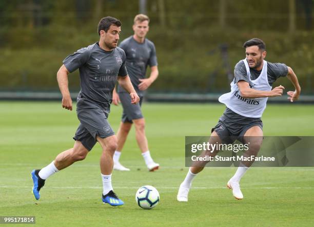 Sokratis and Lucas Perez of Arsenal during a training session at London Colney on July 10, 2018 in St Albans, England.