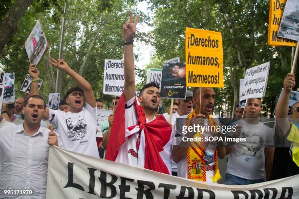 Demonstrators seen shouting slogans with the symbol of the Hirak movement. Members of the Hirak movement in Madrid protest demanding the release of...