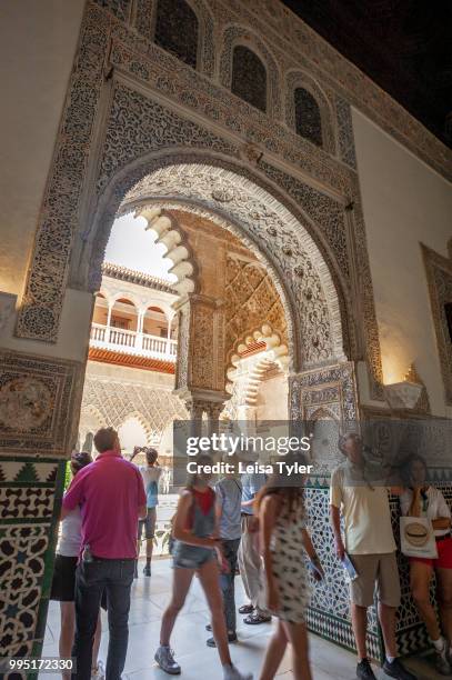 Tourists at the Alcazar of Seville, a royal palace built on the grounds of a Abbadid Muslim fortress in Spain.