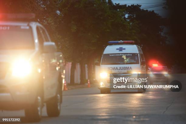 An ambulance transporting alleged members of the children's football team approaches the hospital in the northern Thai city of Chiang Rai on July 10,...