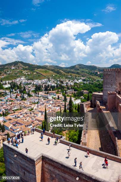 Tourists on the walls of the original citadel, known as Alcazaba, at the Alhambra, a 13th century Moorish palace complex in Granada, Spain. Built on...