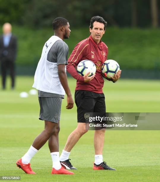 Arsenal Head Coach Unai Emery with Ainsley Maitland-Niles during a training session at London Colney on July 10, 2018 in St Albans, England.