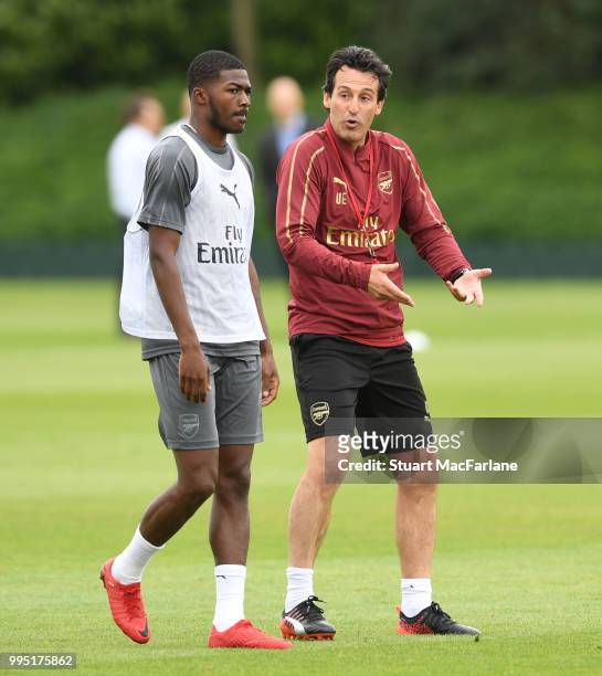 Arsenal Head Coach Unai Emery with Ainsley Maitland-Niles during a training session at London Colney on July 10, 2018 in St Albans, England.