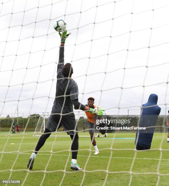 Arsenal goalkeeper Emilino Martinez saves from Jeff Reine-Adelaide during a training session at London Colney on July 10, 2018 in St Albans, England.
