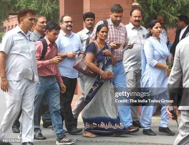 Nirbhaya's parents show victory sign after the Supreme Court's verdict in New Delhi.