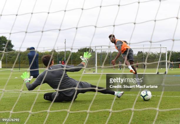 Arsenal's Jeff Reine-Adelaide shoots past Emiliano Martinez during a training session at London Colney on July 10, 2018 in St Albans, England.