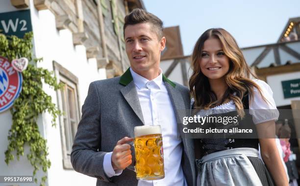 Player of FC Bayern Munich Robert Lewandowski arrives at the "Kaeferzelt" tent with his wife Anna Lewandowska at the Theresienwiese in Munich,...