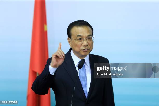 Chinese Premier Li Keqiang makes a speech during a press conference with German Chancellor Angela Merkel following a presentation on autonomous...