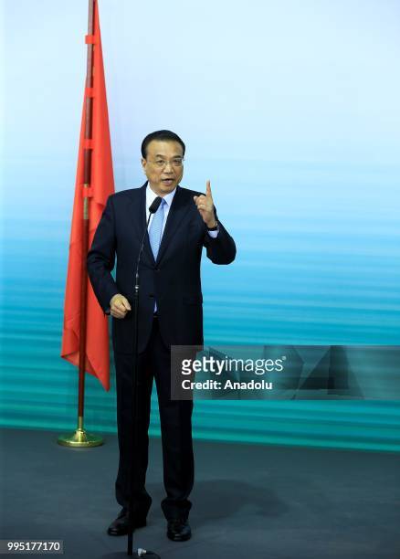 Chinese Premier Li Keqiang makes a speech during a press conference with German Chancellor Angela Merkel following a presentation on autonomous...