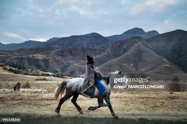 Basotho horseman rides a horse along the road leading to the Maluti Mountains, on July 9, 2018.