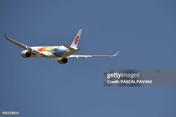 An Airbus A350-900 belonging to the Air China airline company, flies on July 10, 2018 at the Airbus delivery center, in Colomiers southwestern France.