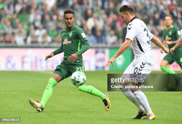 Freiburg's Christian Guenter and Bremen's Theodor Gebre Selassie vie for the ball during the German Bundesliga match between Werder Bremen and SC...