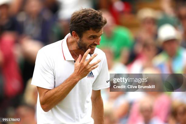 Gilles Simon of France reacts against Juan Martin Del Potro of Argentina during their Men's Singles fourth round match on day eight of the Wimbledon...