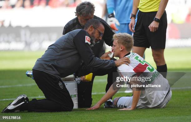 Stuttgart's Timo Baumgartl receives medical attention during the German Bundesliga match between VfB Stuttgart and FC Augsburg at the...