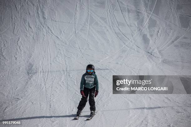 Young skier enjoys a run at Afriski in the Maluti Mountains of the Southern African Kingdom of Lesotho, on July 10, 2018. - Nestled high in the...