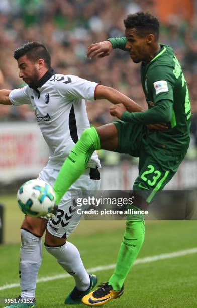 Bremen's Theodor Gebre Selassie and Freiburg's Marco Terrazzino vie for the ball during the German Bundesliga match between Werder Bremen and SC...