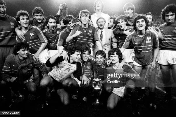 French players pose on June 27, 1984 around the Cup and their coach Michel Hidalgo after winning their first-ever European Nations championship title...