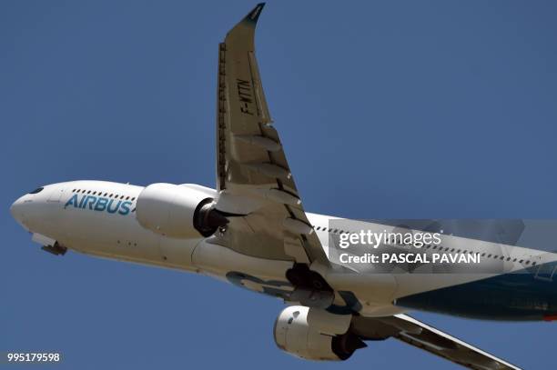 An Airbus A330 neo flies on July 10, 2018 at the Airbus delivery centre, in Colomiers, southwestern France.