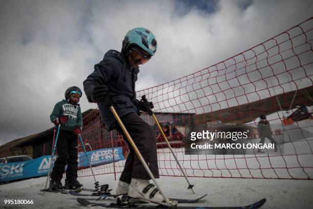 Young skiers get ready for the slope at Afriski in the Maluti Mountains of the Southern African Kingdom of Lesotho, on July 10, 2018. - Nestled high...