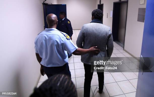 Duduzane Zuma is in shackles during his appearance at the Johannesburg Commercial Crimes Court for corruption charges on July 09, 2018 in...