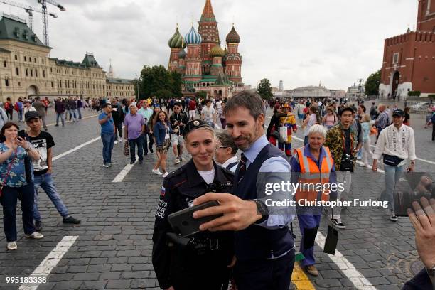 Gareth Southgate lookalike Neil Rowe poses for a selfie with a tourist police officer as he causes a stir as football fans, TV crews and tourists...