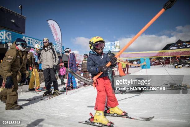 Thabang Mabari from Lesotho, son of chief maintenance officer at Afriski in the Maluti Mountains of the Southern African Kingdom of Lesotho, holds...